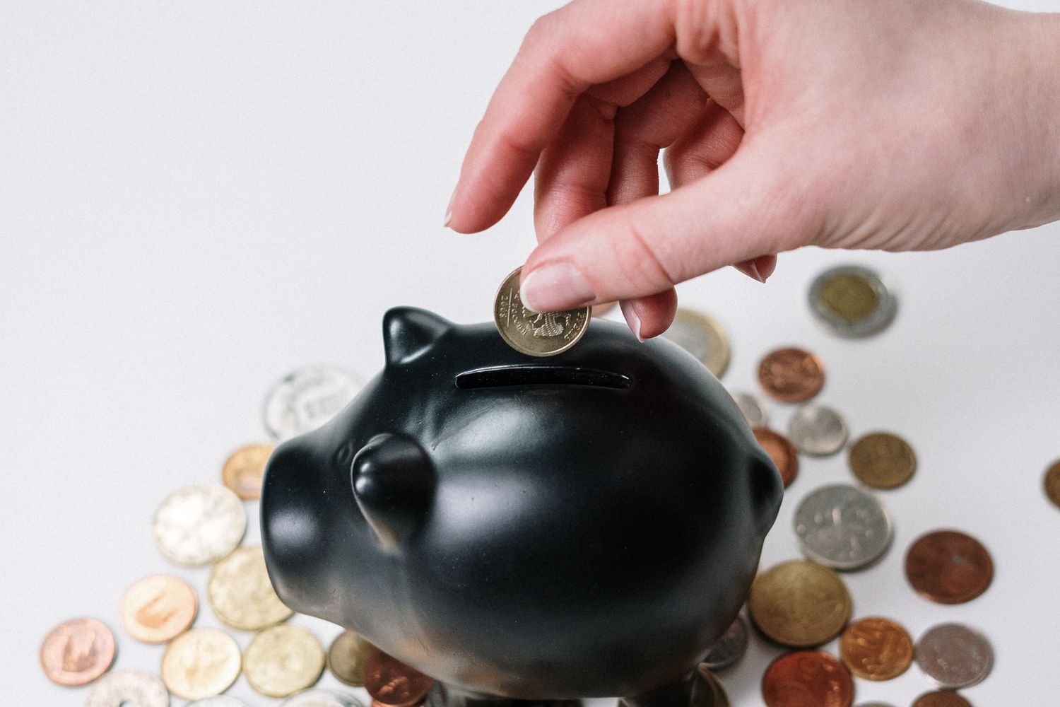 Child learning about money and banking with coins and savings
