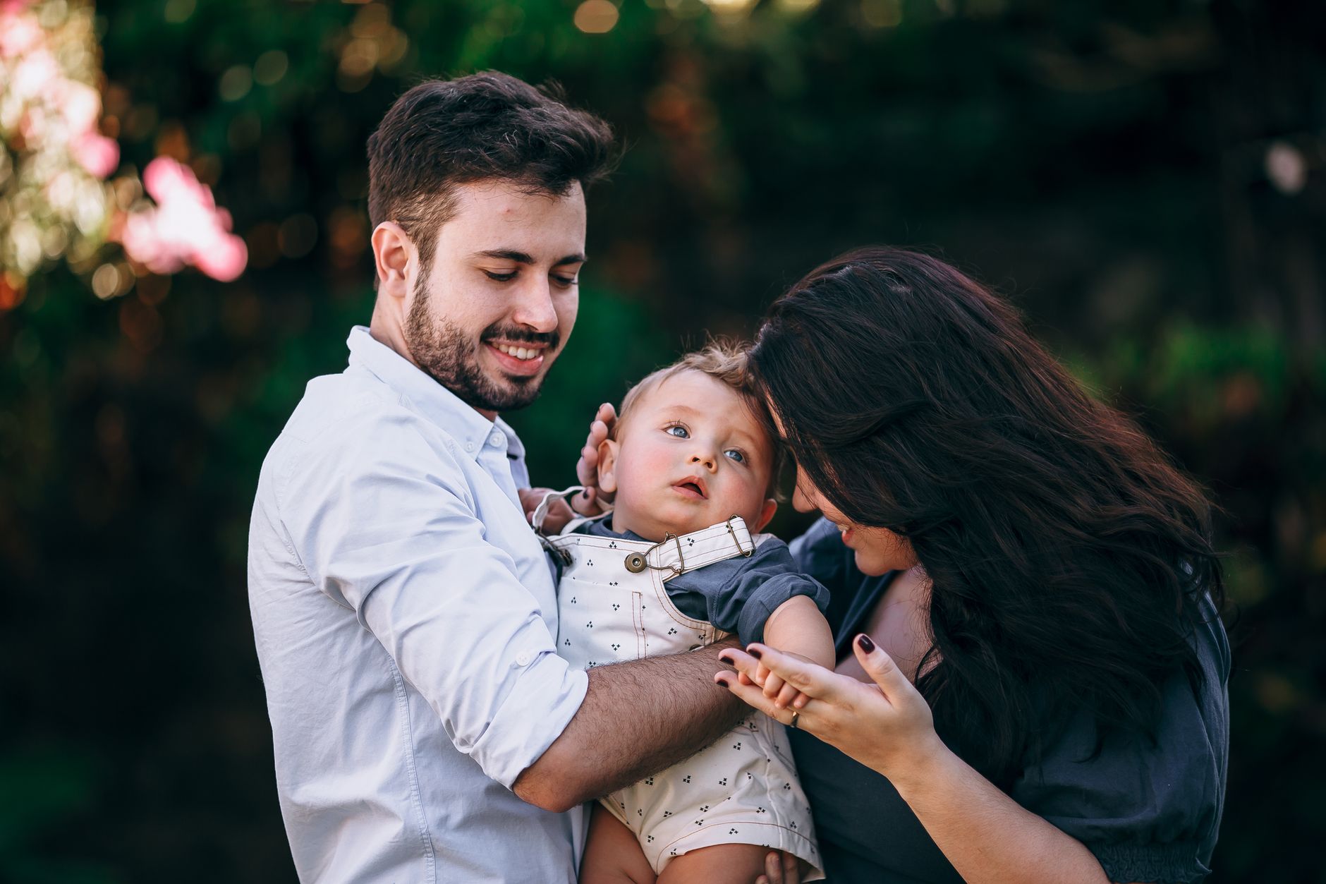 Parent holding baby while reviewing savings account options
