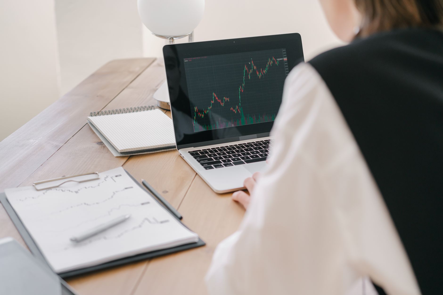 Young person planning financial independence with laptop and charts
