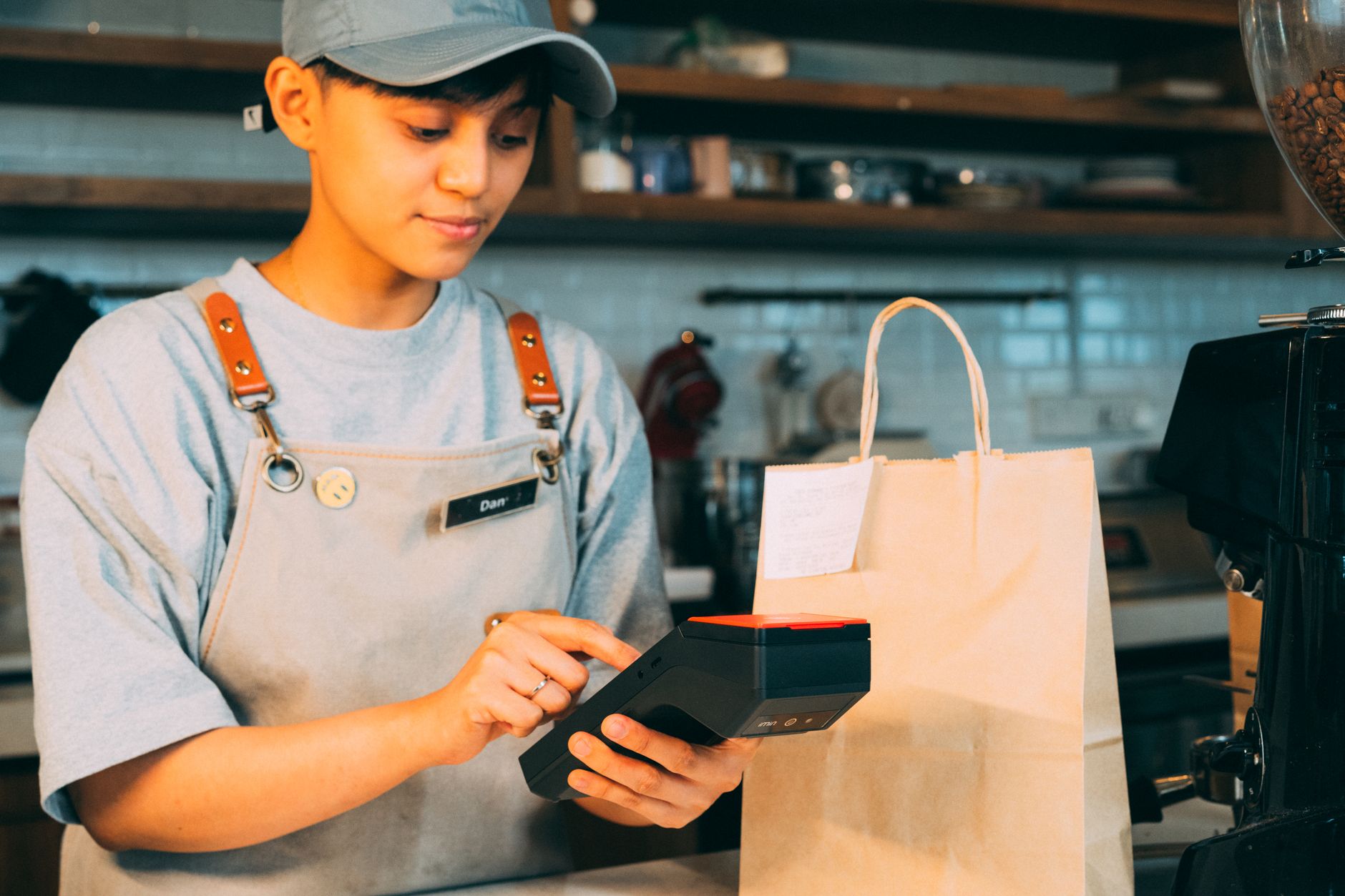 Teenager working as a barista earning their first paycheck