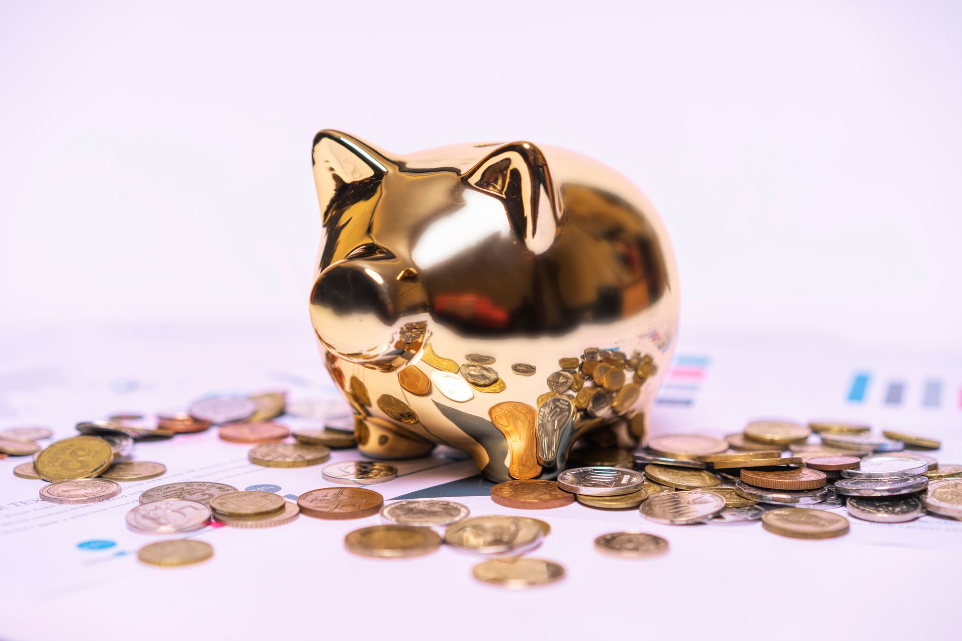 Gold coins and savings bank representing kids financial education