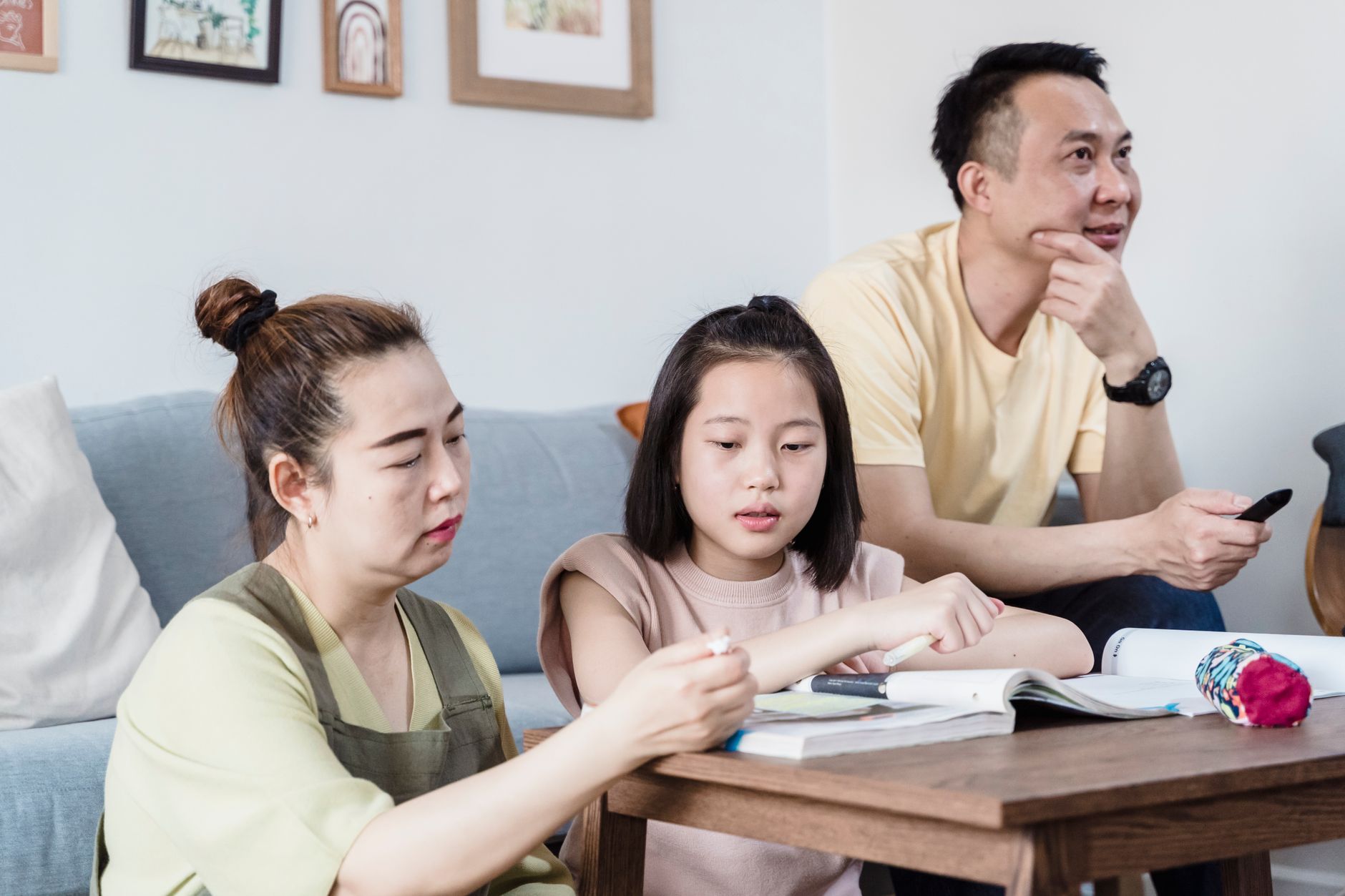 Parent and child discussing money and investing concepts together at home