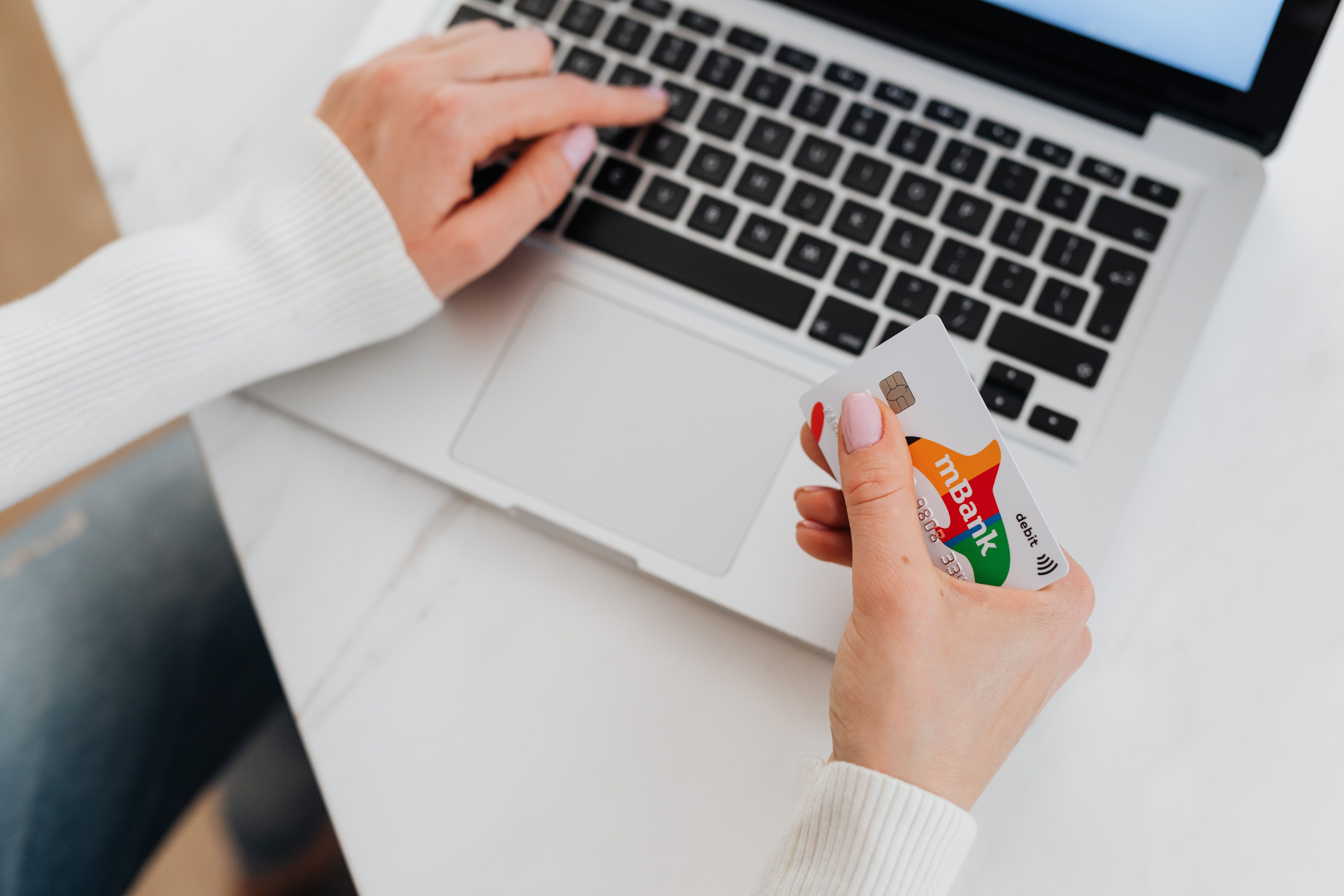 Teenager learning to manage money with a debit card and mobile banking app
