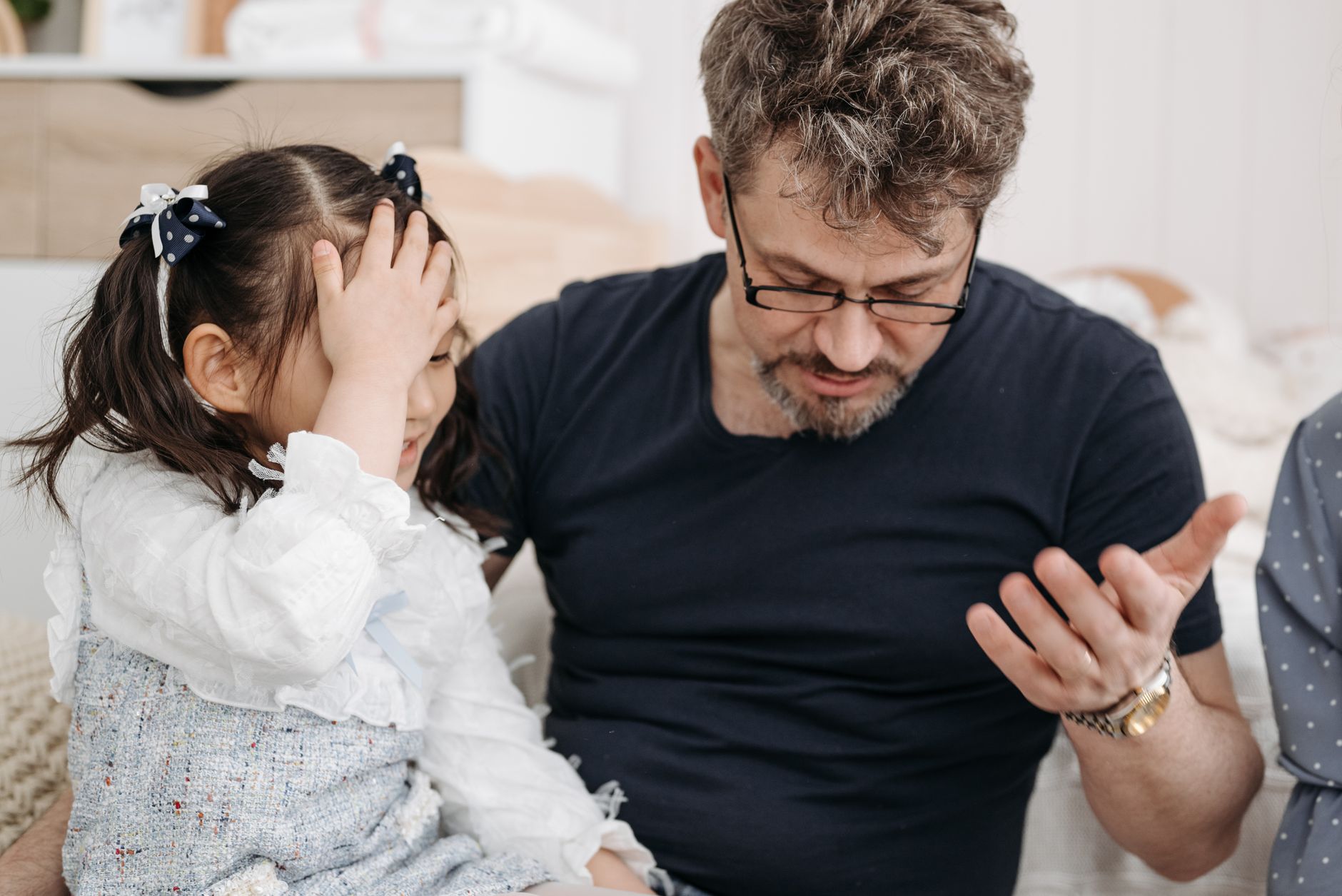 Parent and child sitting together at a kitchen table having a money conversation
