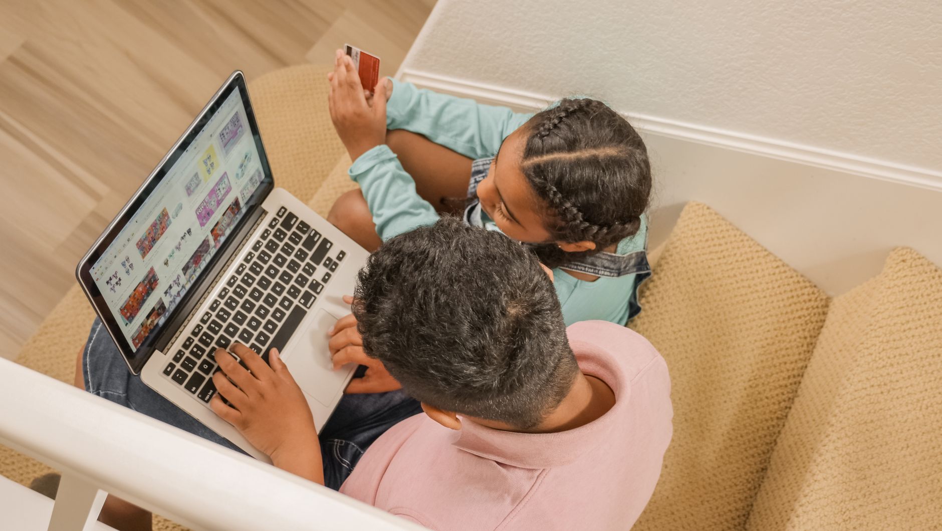 Parent and child sitting at a table learning about money and debt together