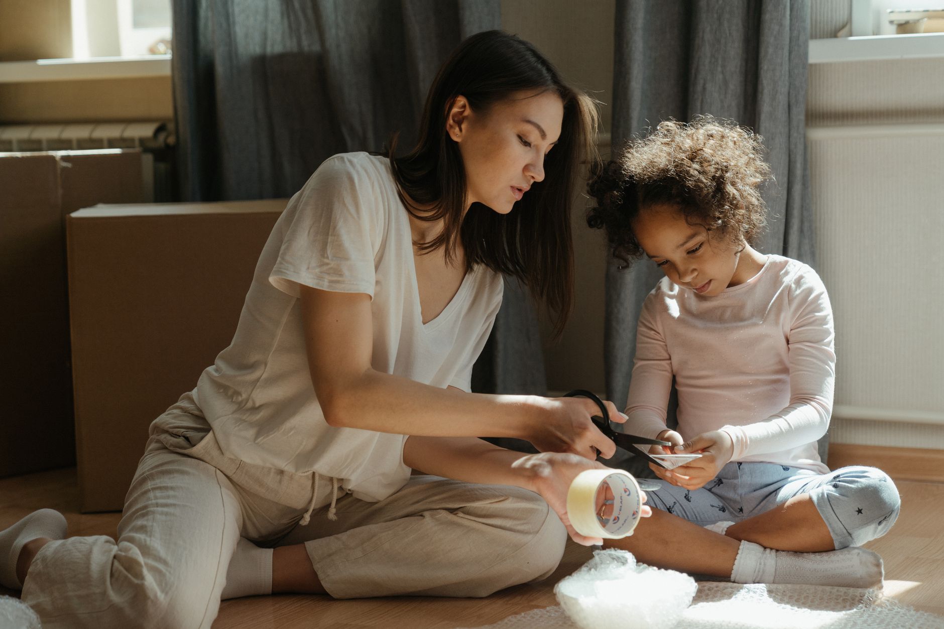 Parent and child sitting together reviewing family finances at home