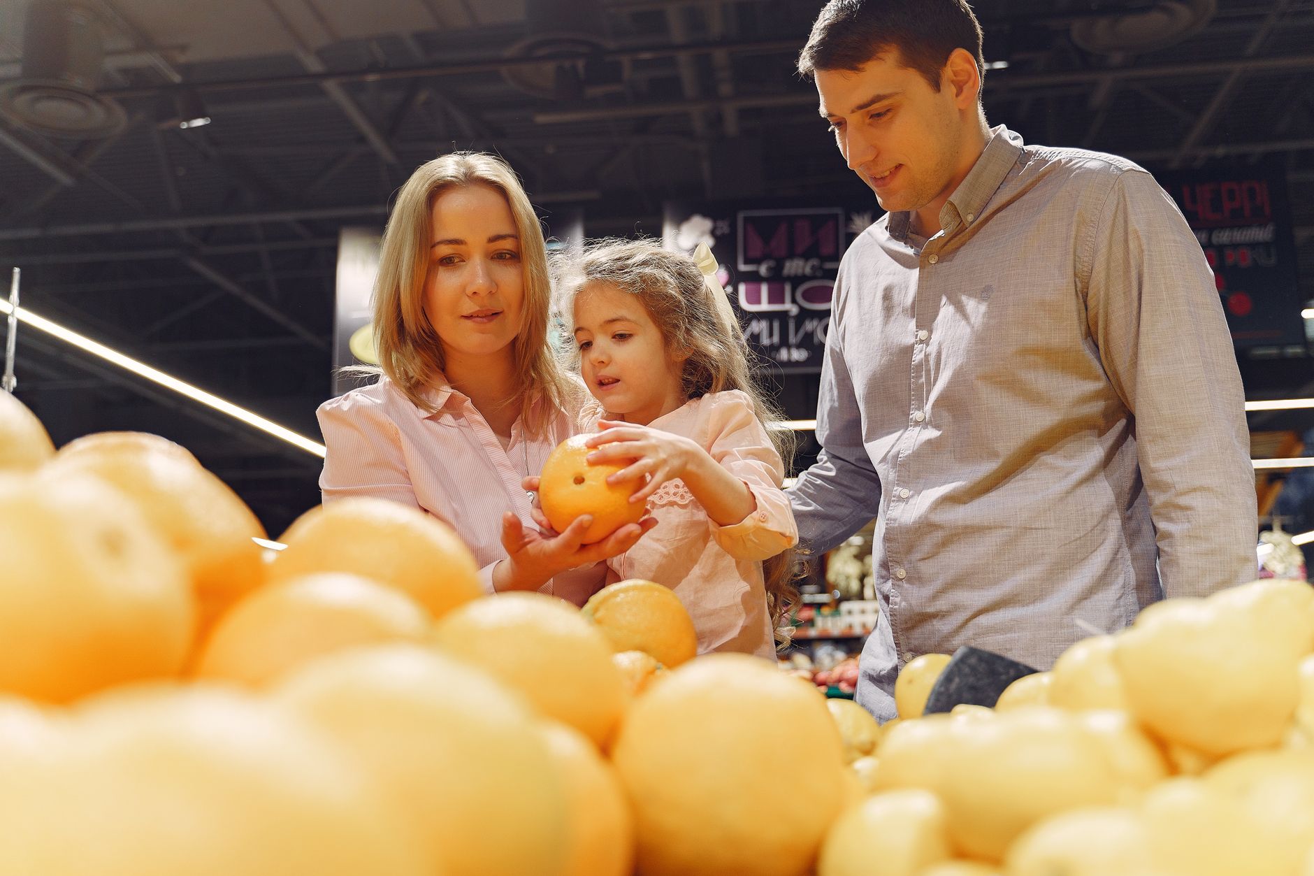 Parent and child making financial decisions while shopping together