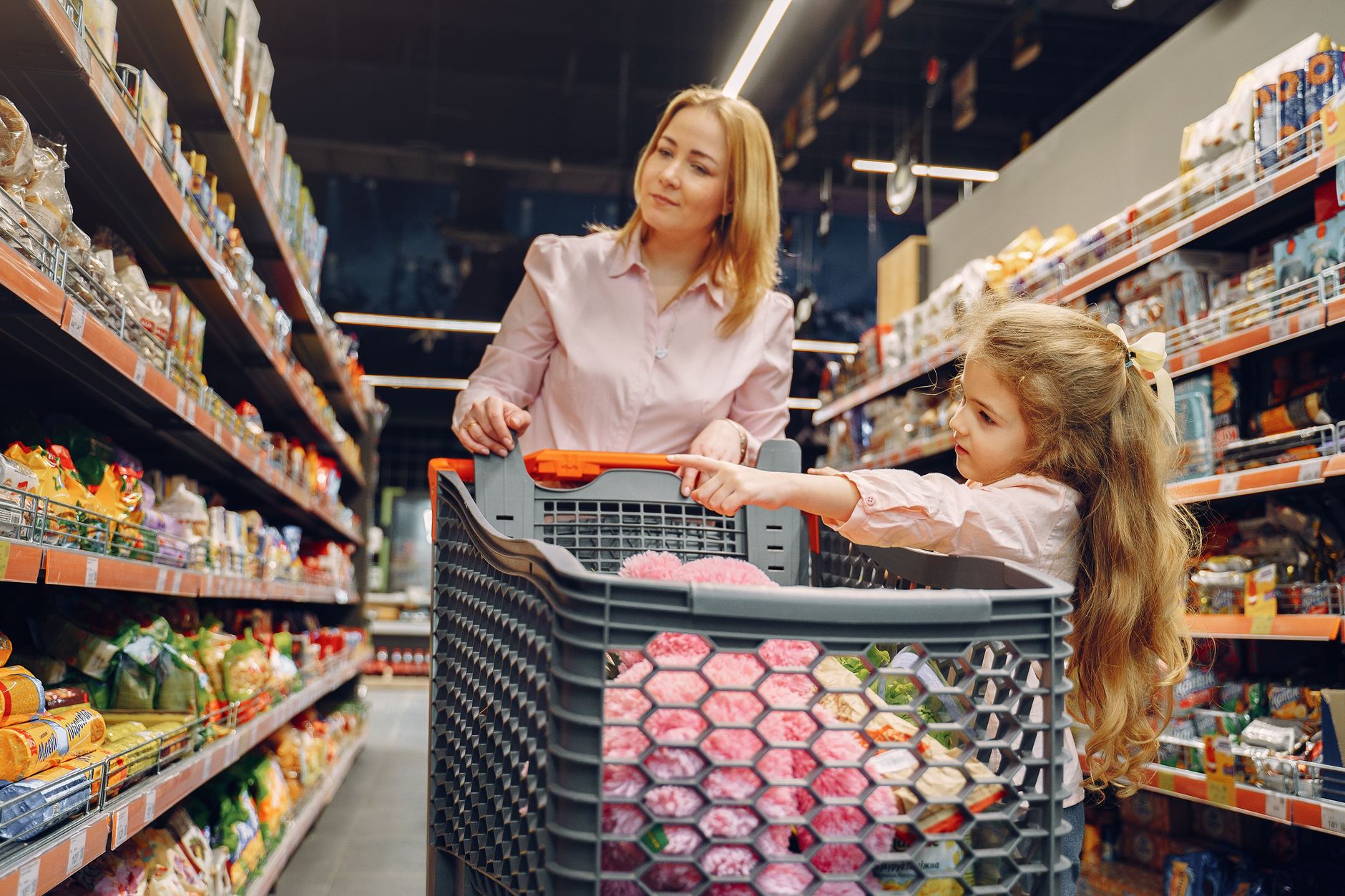 Parent and child shopping together, learning how to spend money wisely