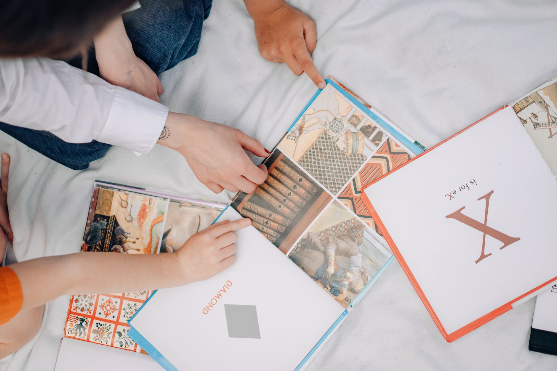 Child reading a money book with parent at home