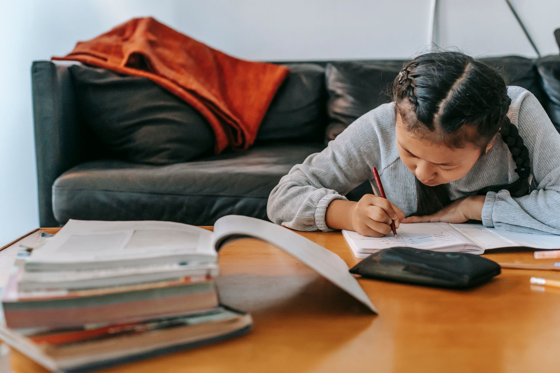 Parent and child working through a kids investing workbook together at a table