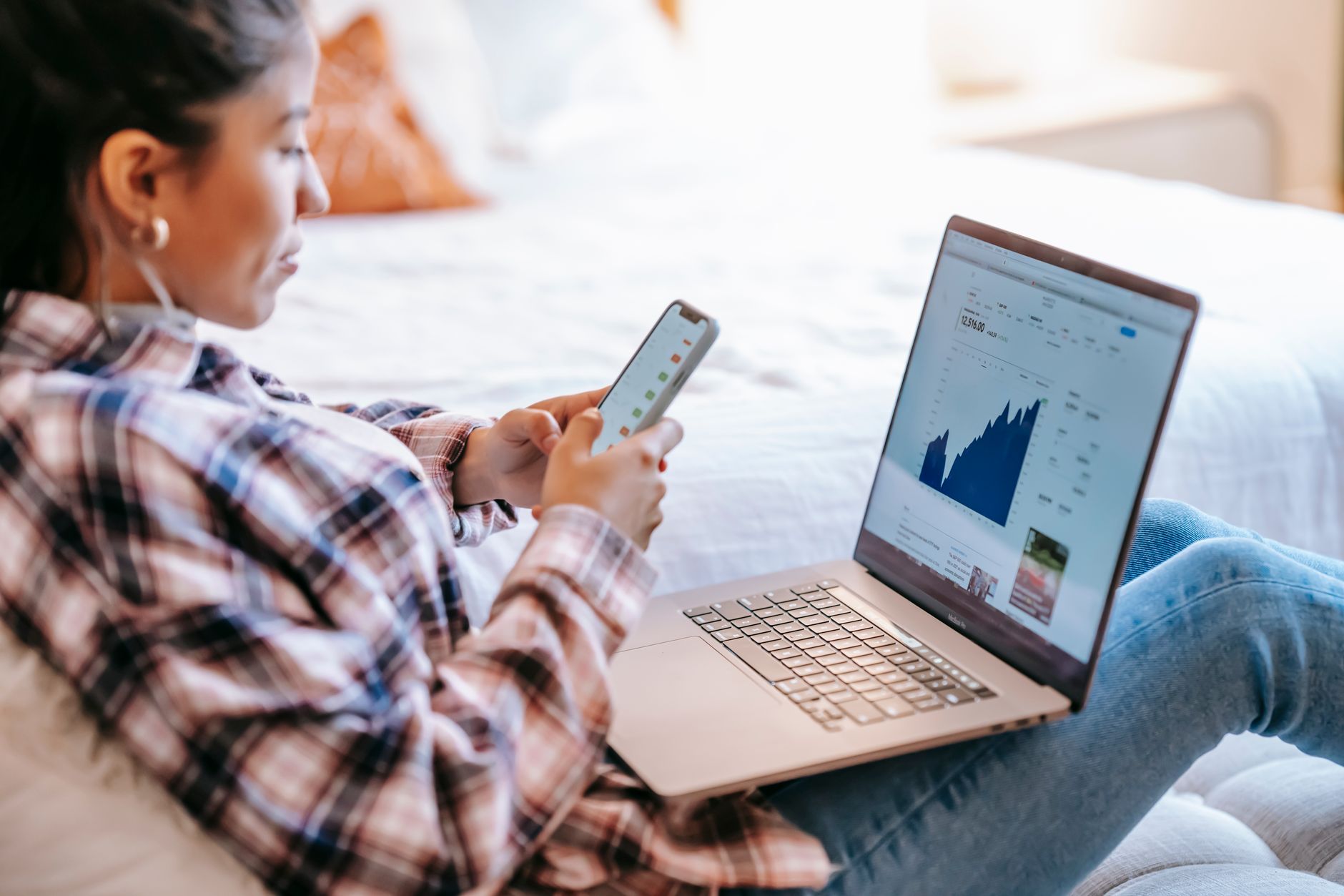 Parent and teenager reviewing Roth IRA investment options together on a laptop