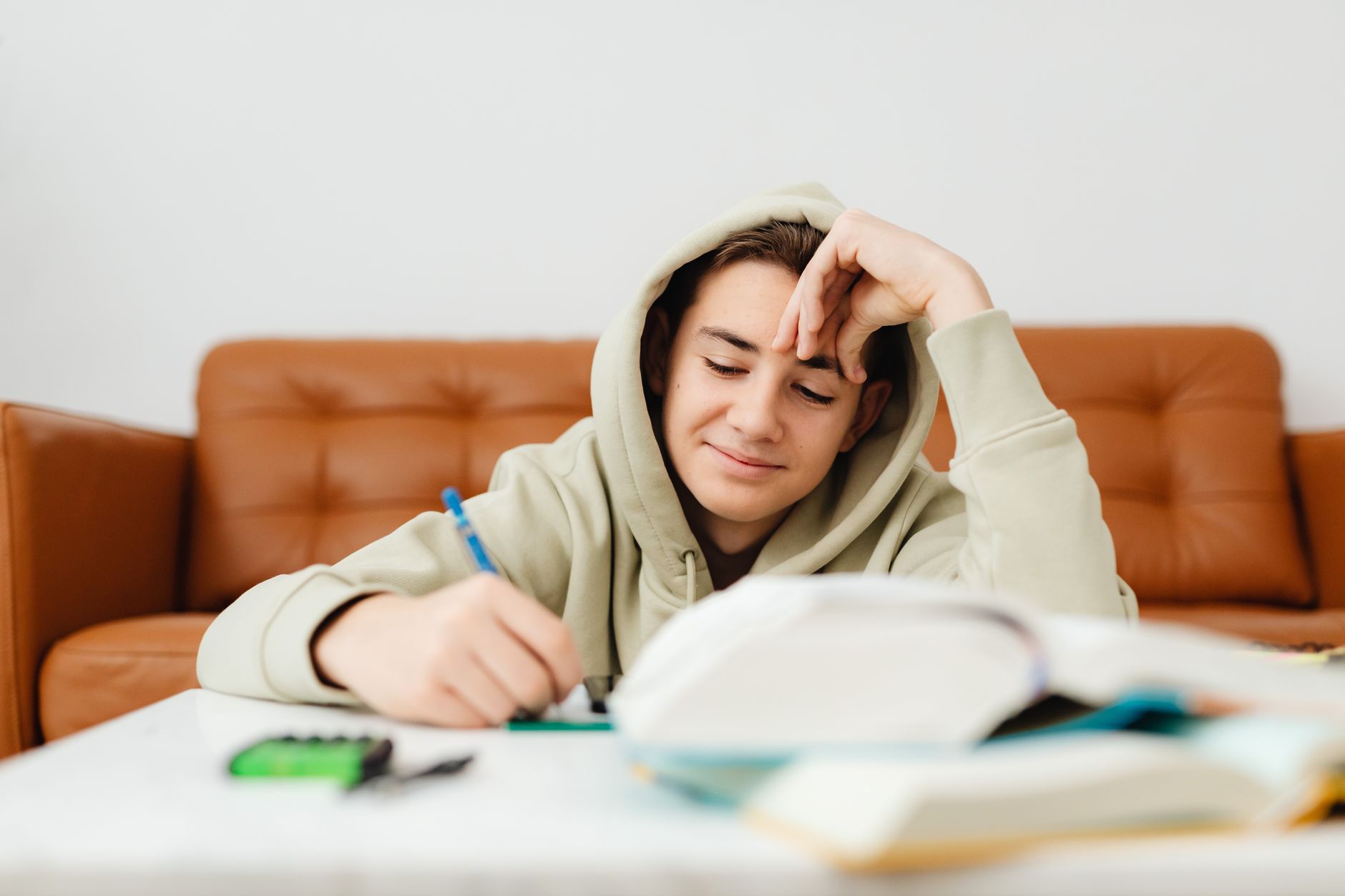 Teen student working through a financial education workbook at a desk