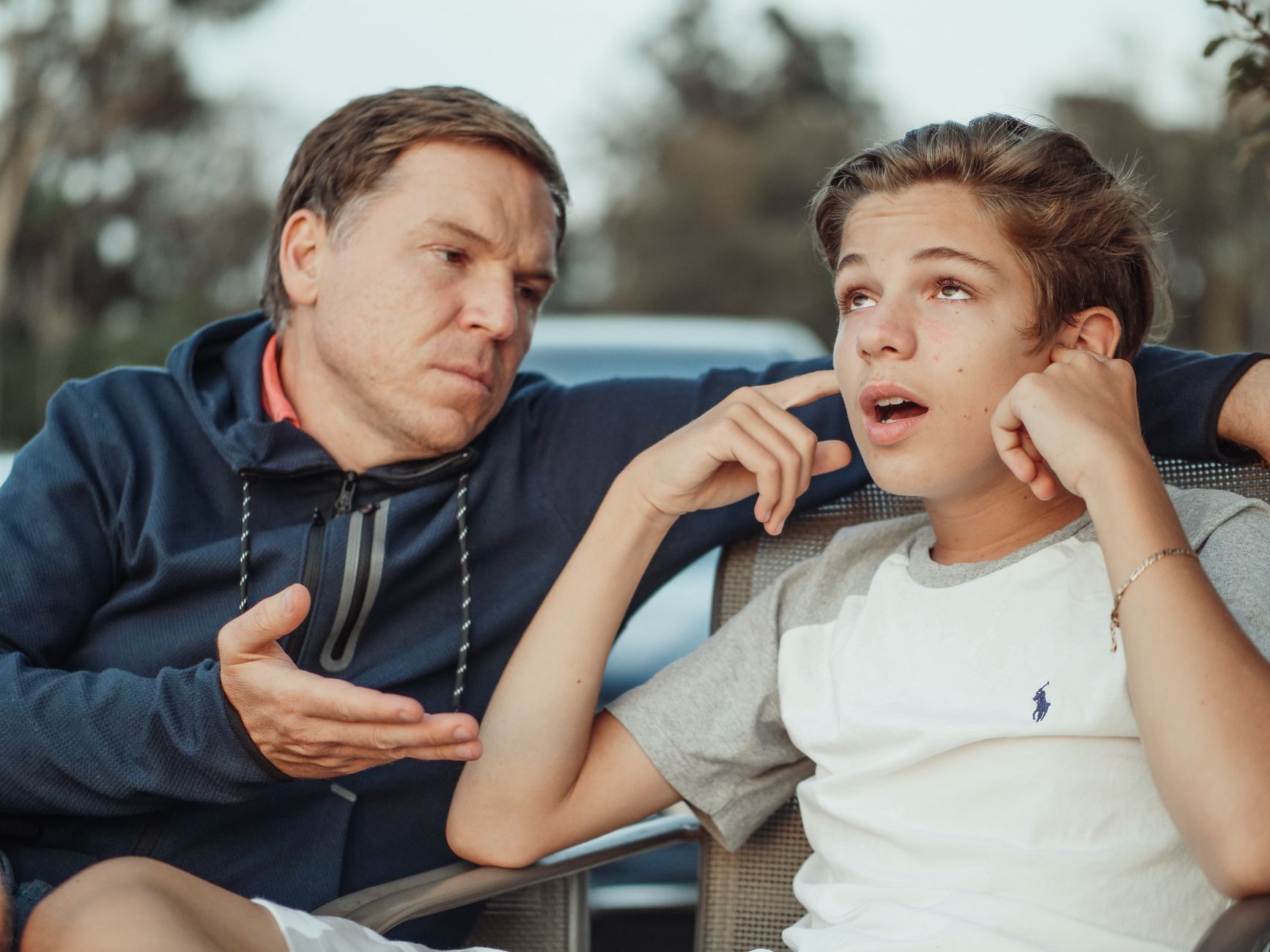 Parent and teenager discussing money and budgeting together
